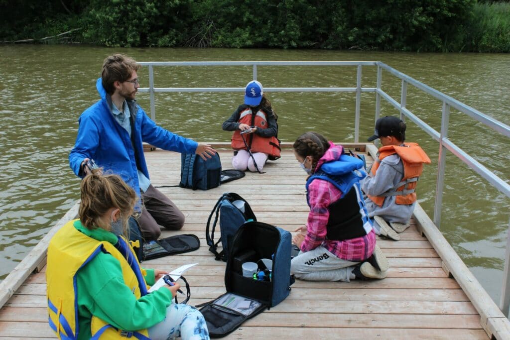 Luke, our education coordinator, talking with students on the dock