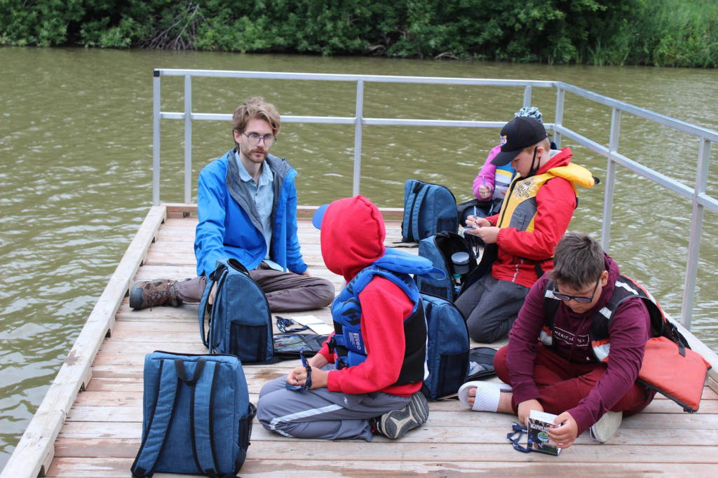 Group water testing on a dock.